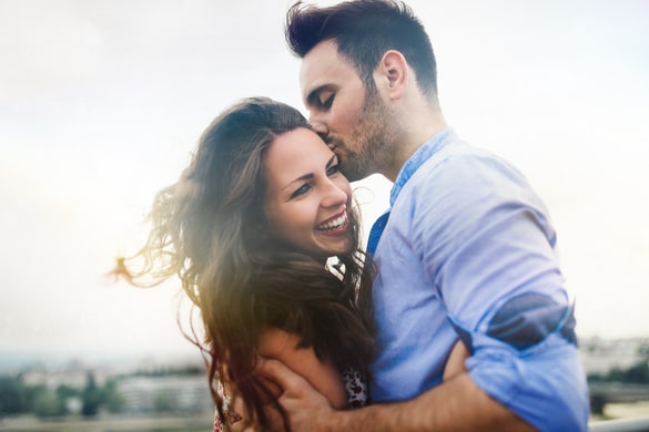 Young couple smiling and hugging