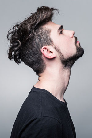 man in black shirt with head tilted up thinking