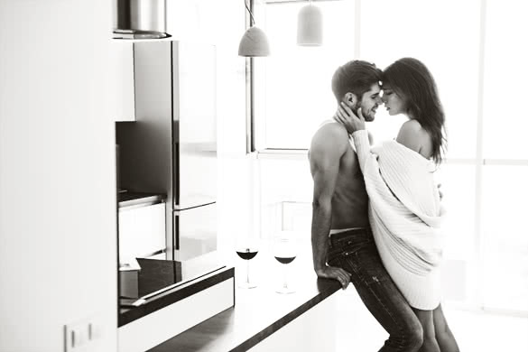 Sexy sensual young couple standing and hugging on the kitchen